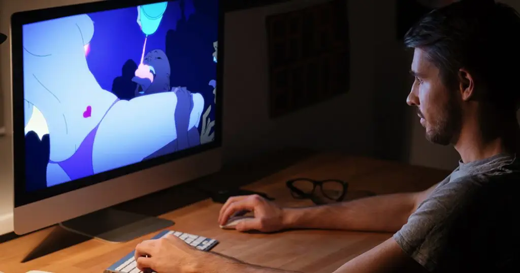 Menikmati Koleksi Anime Digital Gambar seseorang menonton anime di laptopnya.